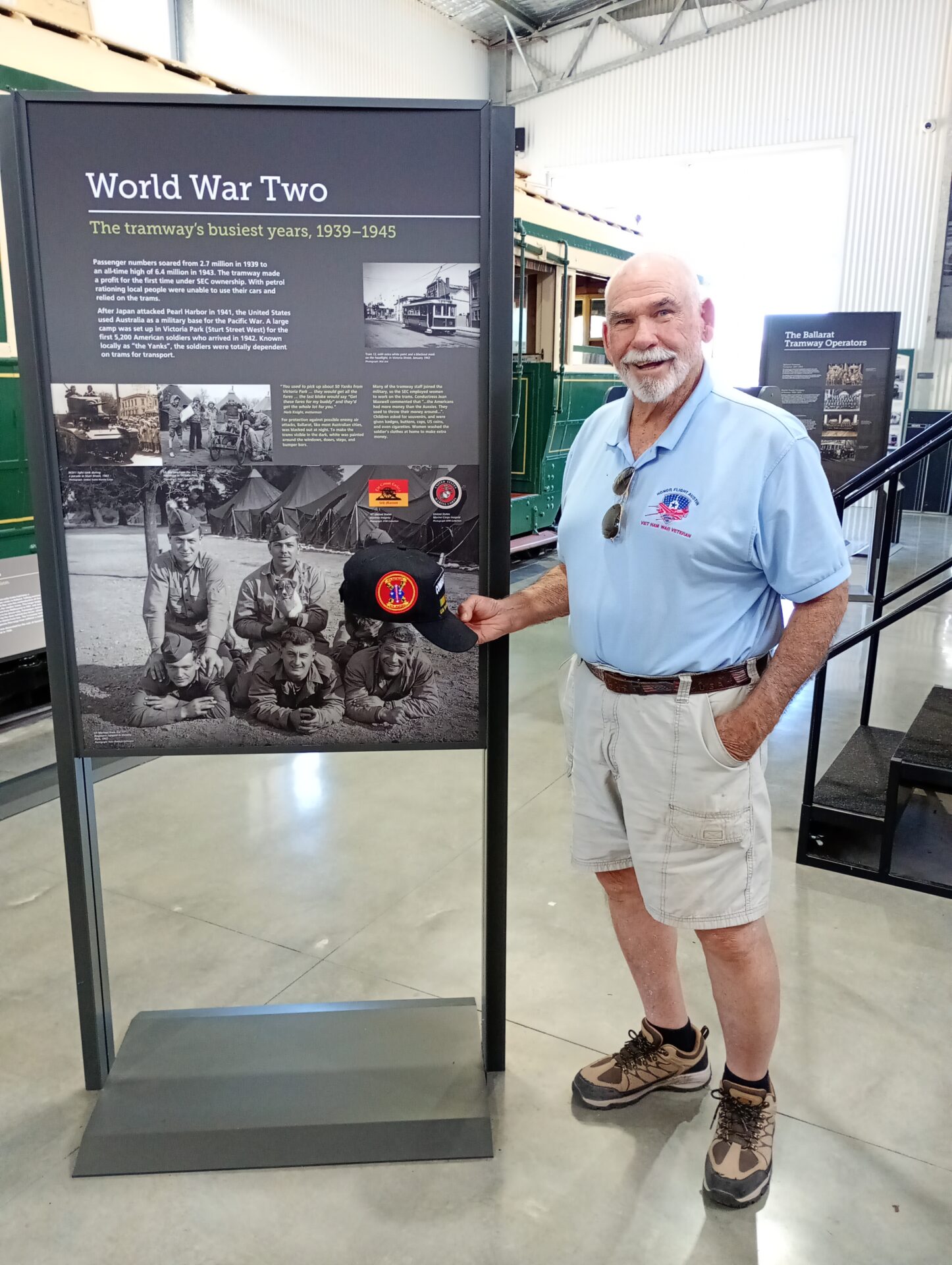 A man standing next to a large display board.