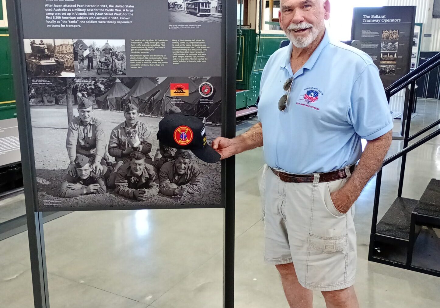 A man standing next to a large display board.