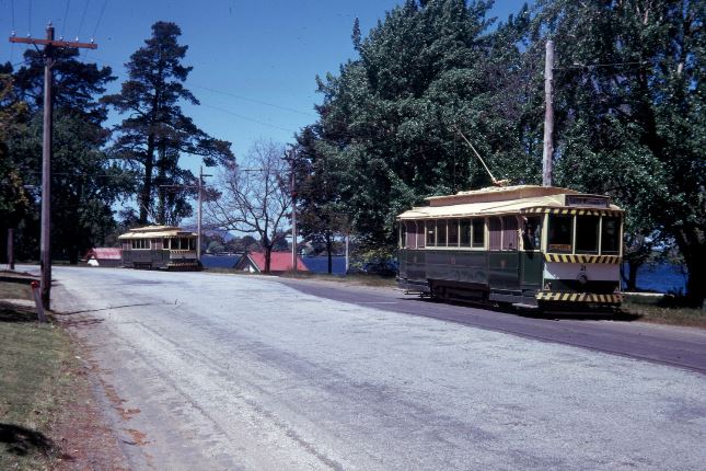 Ballarat 21 and 18 run together in Wendouree Parade, with 21 entering the Car Sheds Loop. The Collection Record photo enlargements show a red signal between the tramcars.
